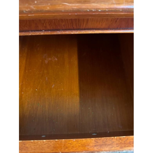 47 - A mahogany veneer sideboard with a bevel edged mirror over and multiple long and short drawer under ... 