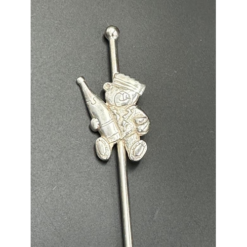 471 - A silver hallmarked stirrer with teddy bear holding a champagne bottle