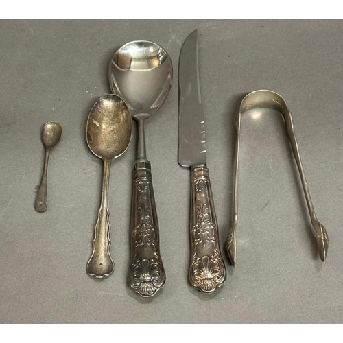 479 - A selection of silver and silver handled items to include sugar tongs, serving spoon, spoon etc.