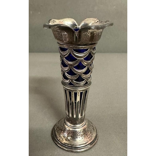 487 - A selection of silver items to include a napkin ring, sugar shaker and a single stem vase with blue ... 