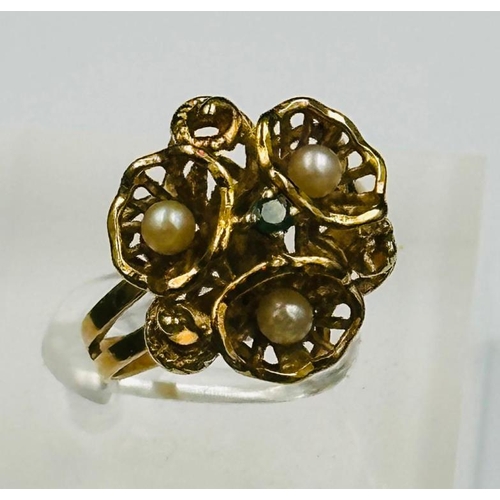 495 - An 18ct gold ring with seed pearl and emerald decoration, approximate weight 6.2g and size M