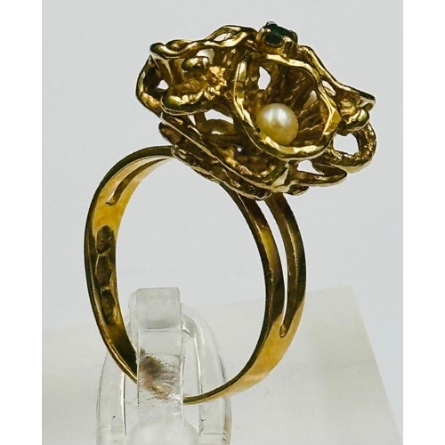 495 - An 18ct gold ring with seed pearl and emerald decoration, approximate weight 6.2g and size M