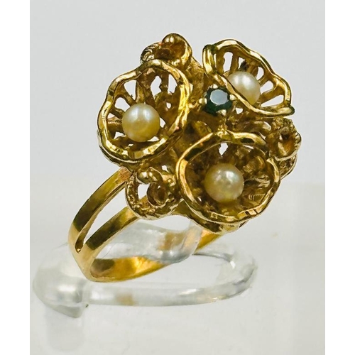 495 - An 18ct gold ring with seed pearl and emerald decoration, approximate weight 6.2g and size M