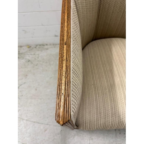 5 - An oak framed Art Deco lounge chair in a beige upholstery