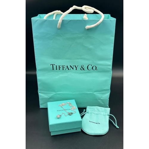 520 - A Tiffany and Co Elsa Peretti Open Heart Lariat Necklace with original pouch and bag