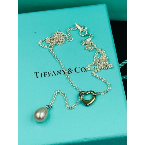 520 - A Tiffany and Co Elsa Peretti Open Heart Lariat Necklace with original pouch and bag