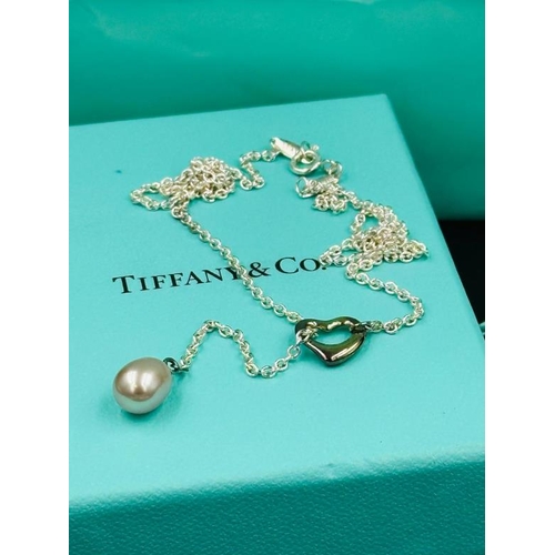 520 - A Tiffany and Co Elsa Peretti Open Heart Lariat Necklace with original pouch and bag