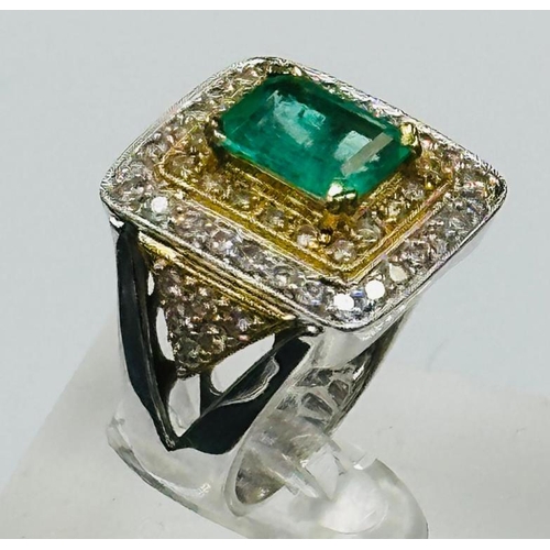 529 - An emerald and diamond three tier square cluster ring with diamond set shoulders.Central emerald cut... 