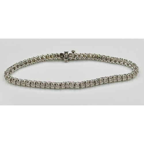 530 - A diamond line bracelet, approximately sixty round brilliant cut diamonds weighing on estimated tota... 