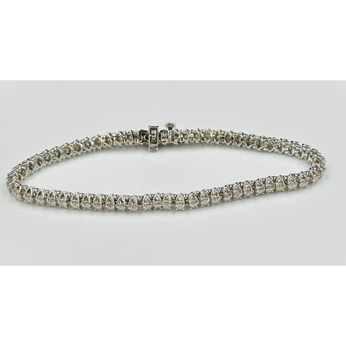 530 - A diamond line bracelet, approximately sixty round brilliant cut diamonds weighing on estimated tota... 