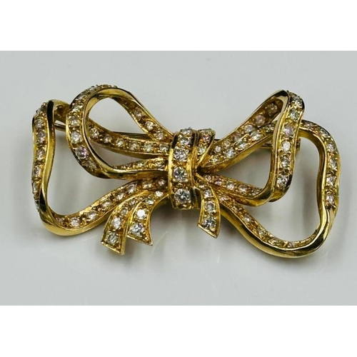 531 - A Diamond and 18ct Gold Late Twentieth Century Bow brooch. Approximate combined diamond weight of 3.... 