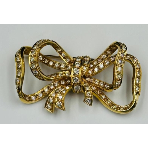 531 - A Diamond and 18ct Gold Late Twentieth Century Bow brooch. Approximate combined diamond weight of 3.... 