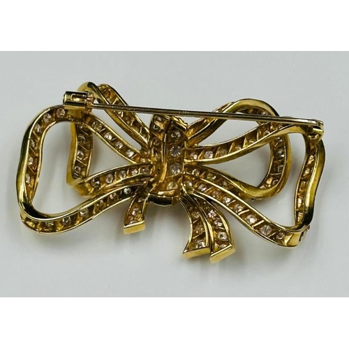 531 - A Diamond and 18ct Gold Late Twentieth Century Bow brooch. Approximate combined diamond weight of 3.... 