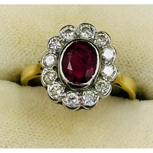 591 - A ruby and diamond daisy ring on an 18ct yellow gold setting, approximate size L.5