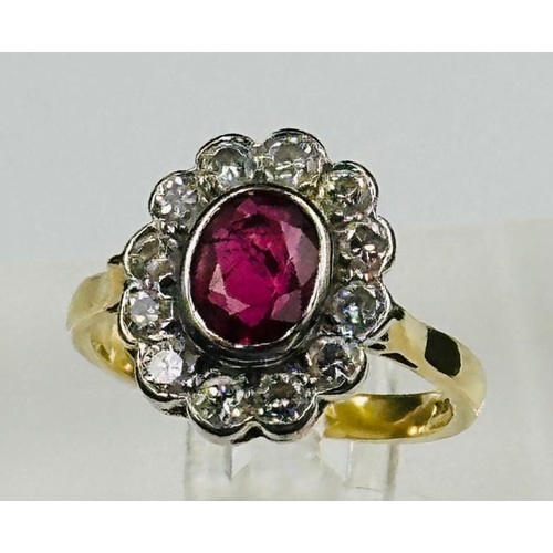 591 - A ruby and diamond daisy ring on an 18ct yellow gold setting, approximate size L.5