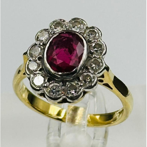 591 - A ruby and diamond daisy ring on an 18ct yellow gold setting, approximate size L.5