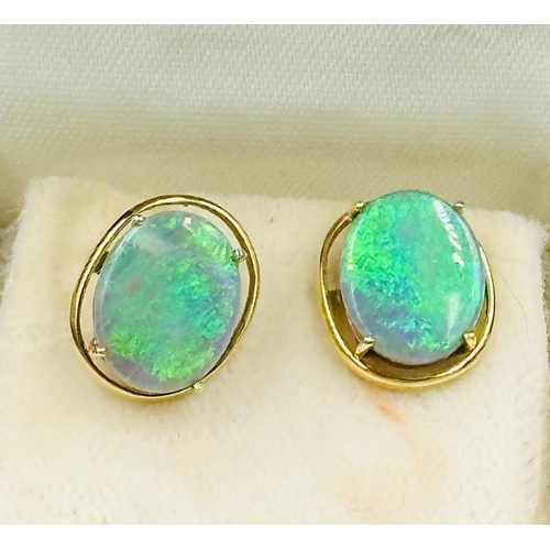 593 - A pair of opal earrings in yellow gold setting