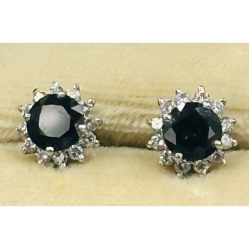 594 - A pair of sapphire and diamond stud earrings