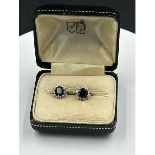 594 - A pair of sapphire and diamond stud earrings