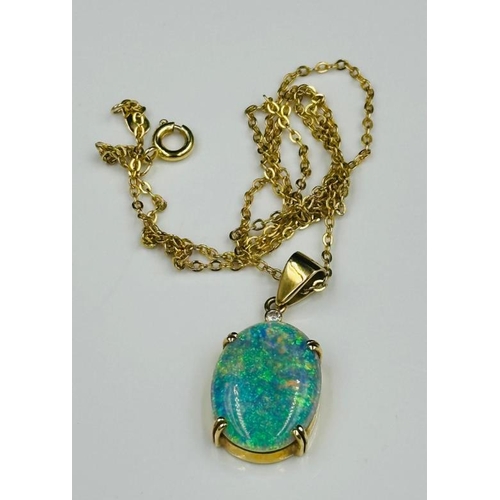 595 - An opal pendant (20mm x 15mm) on a marked 750 setting and fine necklace.