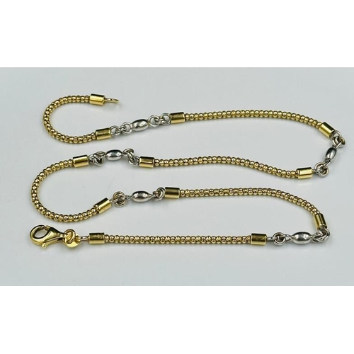 602 - An 18ct two colour gold necklace, marked 750 with an approximate weight of 12.7g