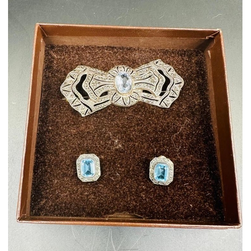 605 - A blue stone and marcasite brooch and earring set.