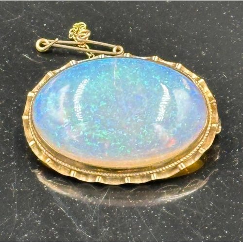 664 - A opal style brooch with safety chain on a 9ct gold mount and approximately 37mm in width.