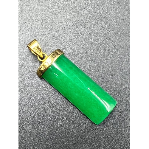 666 - A Jade pendant set with 18ct gold plate.