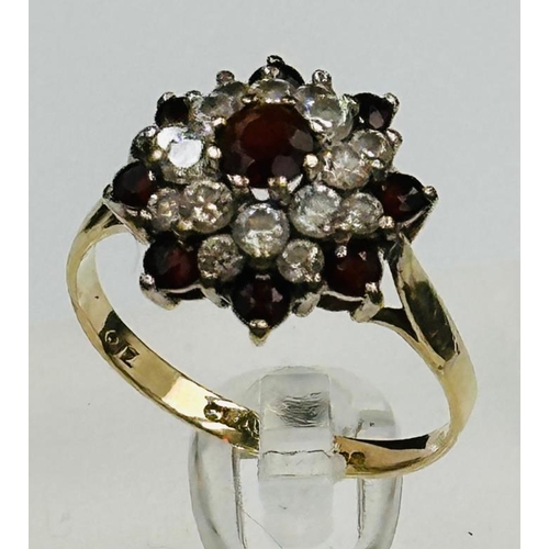 668 - A 9ct gold garnet and cz ring size O and approximate weight 2.7g