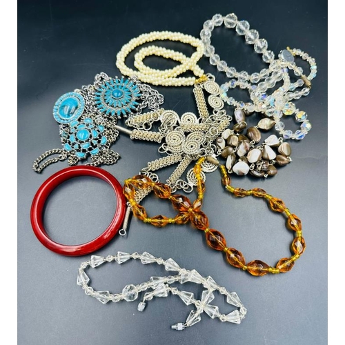 690 - A selection of costume jewellery to include turquoise, amber etc.