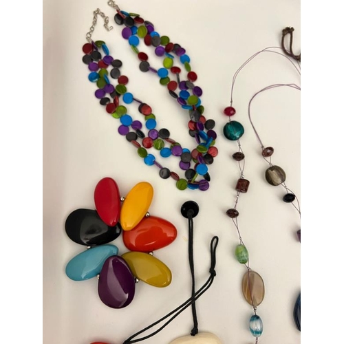 702 - A collection of vibrant costume jewellery, multi pebble style necklaces, beaded Bohemian styles etc