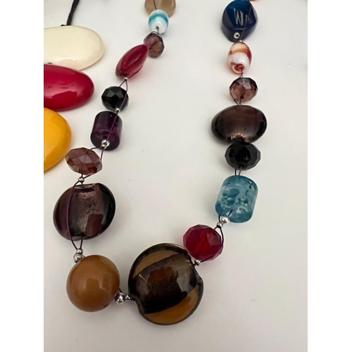 702 - A collection of vibrant costume jewellery, multi pebble style necklaces, beaded Bohemian styles etc