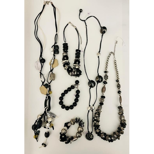 703 - A collection of beaded long necklaces, onyx style black bracelet and other styles