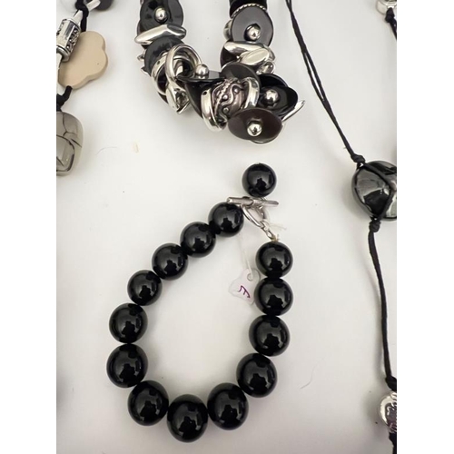 703 - A collection of beaded long necklaces, onyx style black bracelet and other styles