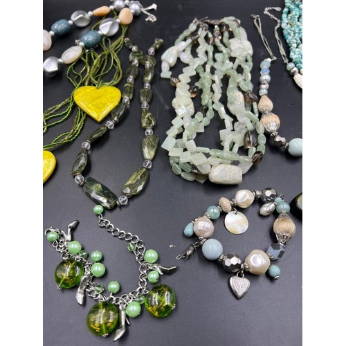 704 - A collection of costume jewellery multistrand layered necklaces, semi precious stone  beaded necklac... 