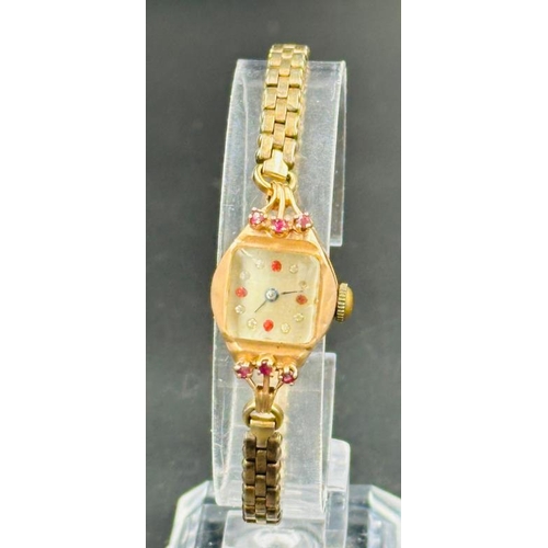 724 - A 14ct gold Ladies cocktail watch with ruby decorative stones