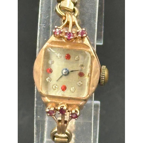 724 - A 14ct gold Ladies cocktail watch with ruby decorative stones