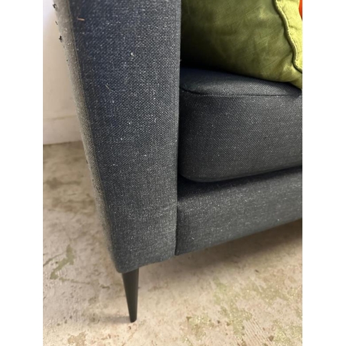 73 - A contemporary charcoal grey two seater sofa with button back cushions