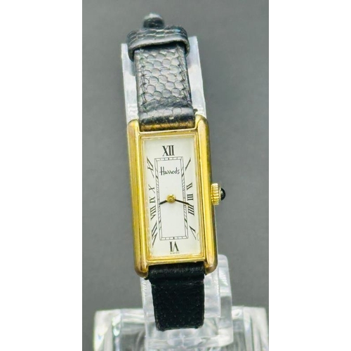 731 - A Ladies Harrods wristwatch on a leather strap.