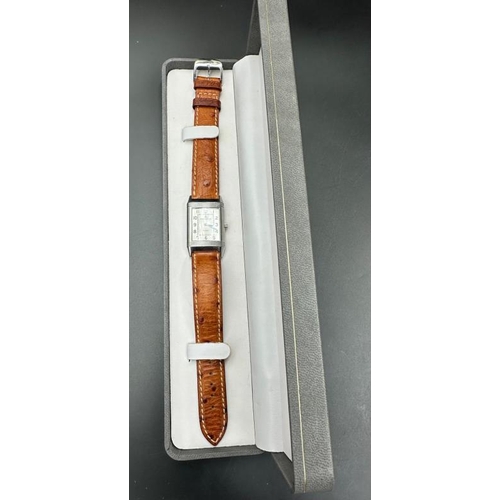 732 - A Jaeger Le Coultre Reverso on an ostrich strap No 250886, with original papers.