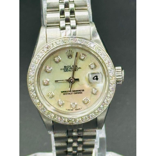 735 - A Rolex Oyster Perpetual watch, round white mother of peral dial, diamond dot indices to diamond set... 