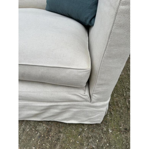 76 - The Conran Shop, a large cream linen three seater sofa (H86cm W240cm D110cm SH44cm)