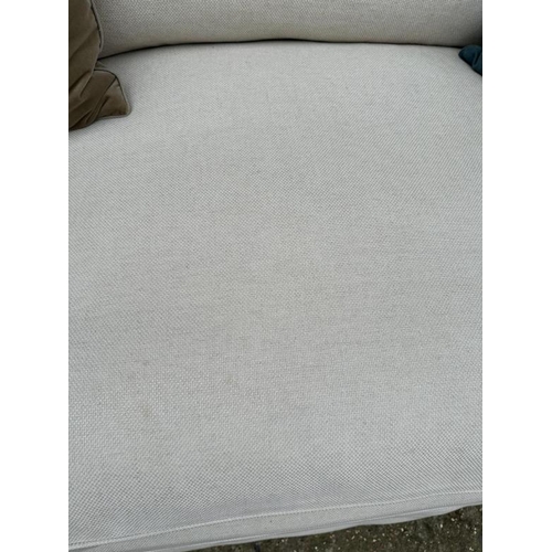 76 - The Conran Shop, a large cream linen three seater sofa (H86cm W240cm D110cm SH44cm)