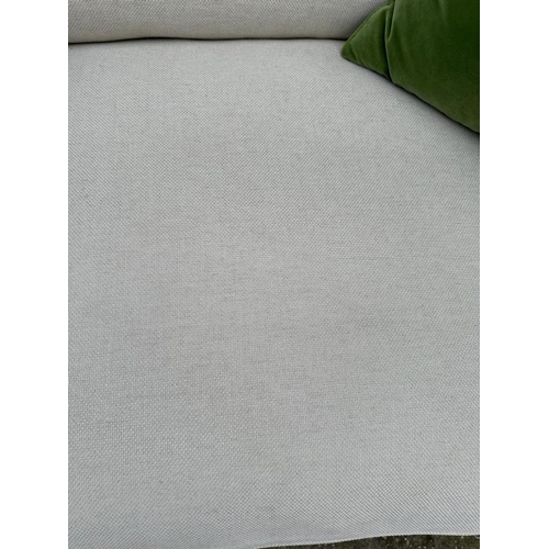 77 - The Conran Shop, a large cream linen three seater sofa (H86cm W240cm D110cm SH44cm)