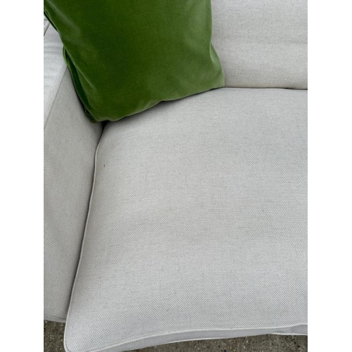 77 - The Conran Shop, a large cream linen three seater sofa (H86cm W240cm D110cm SH44cm)