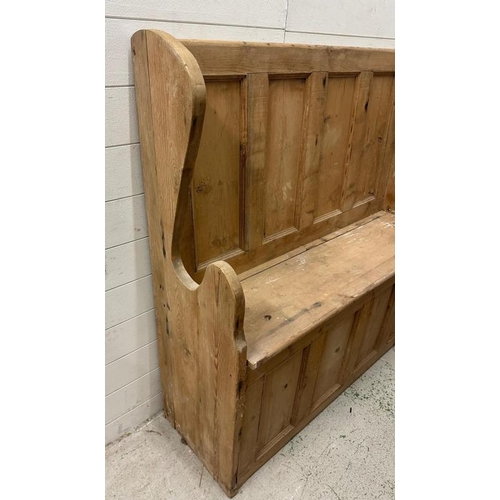 79 - A reclaimed pine settle or bench with hinged lift up seat opening to storage (H122cm W123cm D36cm)