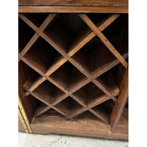 90 - An Indian mahogany campaign style extendable drinks cabinet. The two doors opening to bar with bottl... 