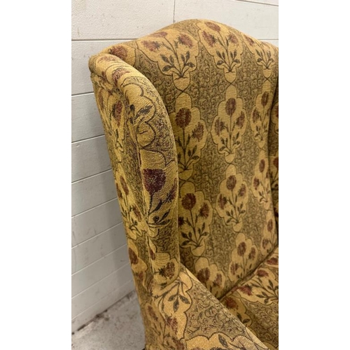 91 - A wingback arm chair with floral upholstery