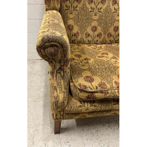 91 - A wingback arm chair with floral upholstery