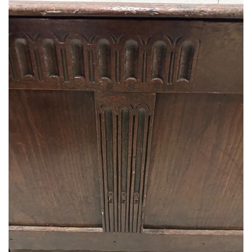 95 - A large oak panelled coffer with hinged lid (H62cm W130cm D57cm)